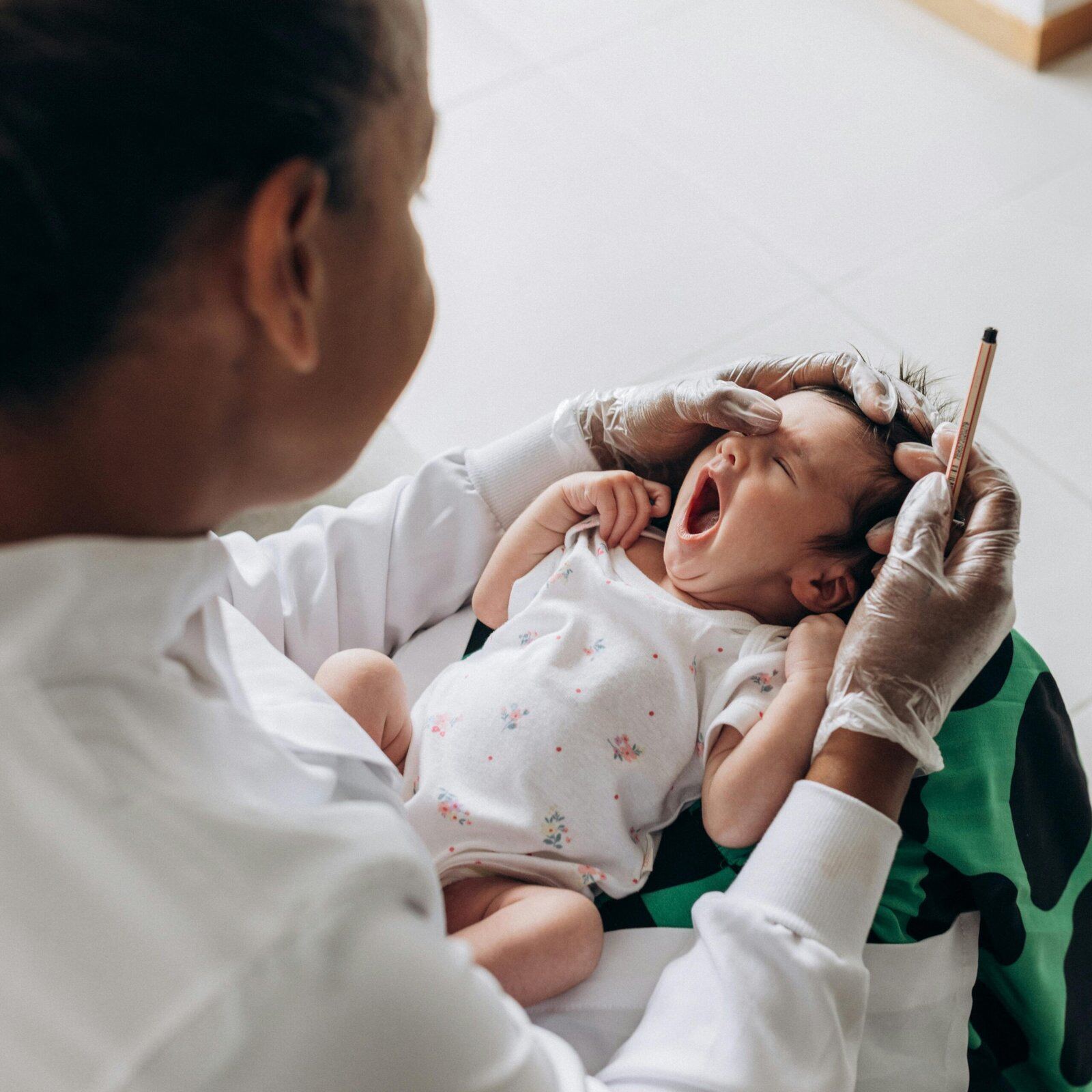 Paediatrician with child at clinic Paediatrician examining a child at Paedix clinic